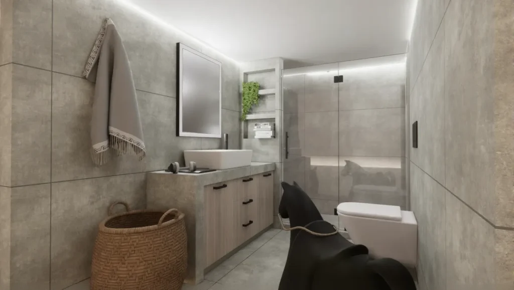 Μοντέρνο μπάνιο σε γκρι αποχρώσεις με πλακάκια όψης τσιμέντου, κτιστό πάγκο με ξύλινα ντουλάπια, γυάλινη ντουζιέρα και ένα μαύρο κουνιστό αλογάκι ως διακοσμητικό στοιχείο.